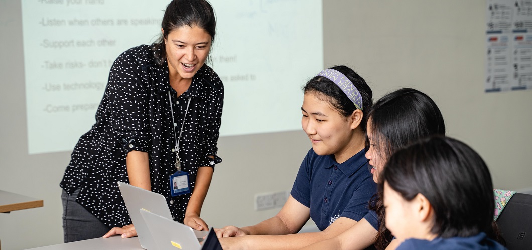 Teacher assisting students in class