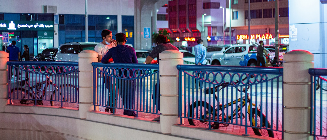People with bicycles leaning on a handrail in Abu Dhabi