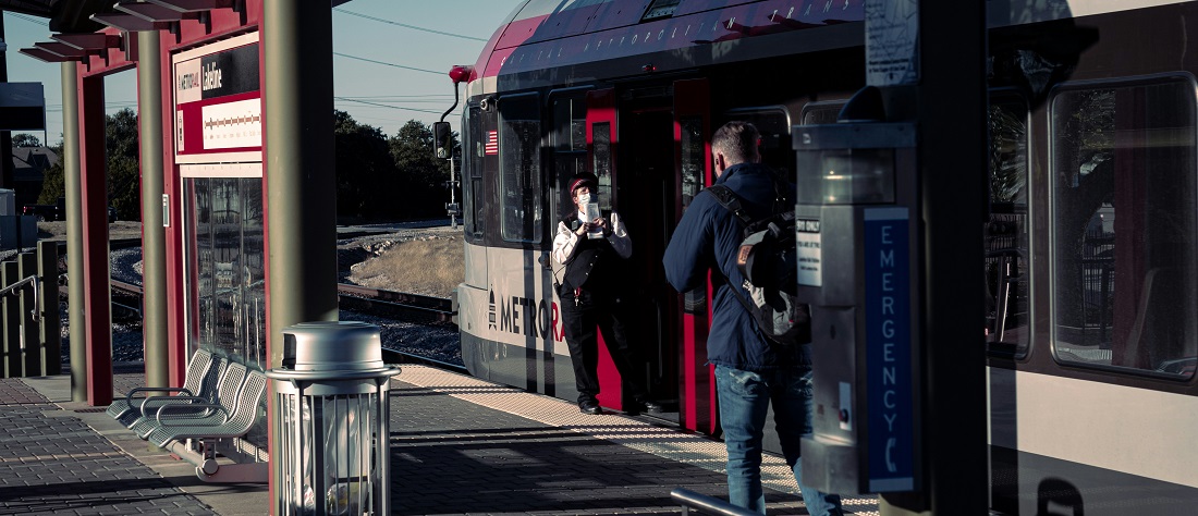 Passenger getting on a MetroRail train by Dylan Hunter