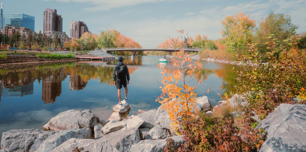 Hiker on Bow River in Downtown Calgary by Ryunosuke Kikuno