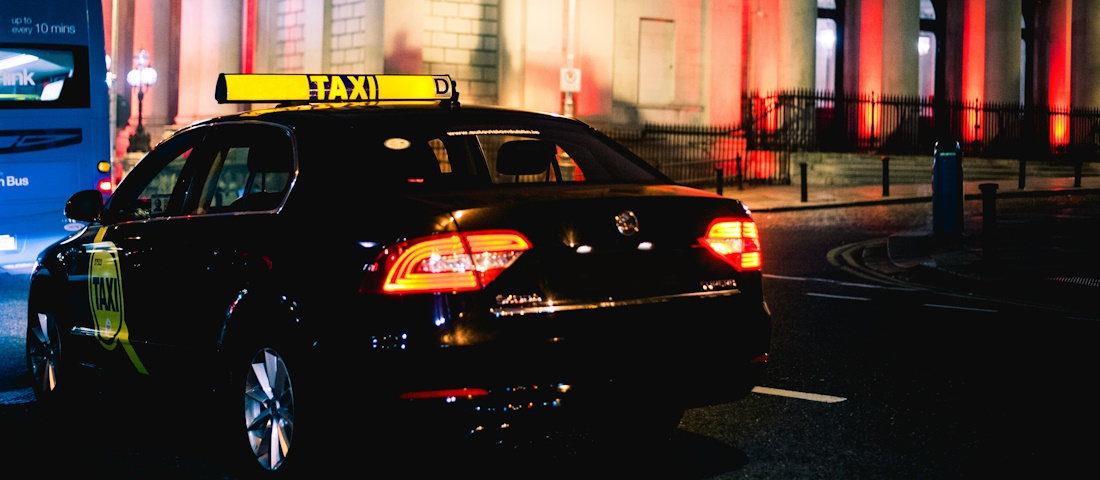 Black taxi at night by Naseem Buras