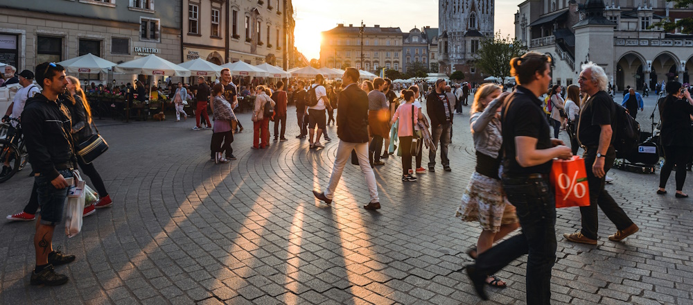 Pedestrians on Main Market Square in Krakow by Jacek Dylag on Unsplash