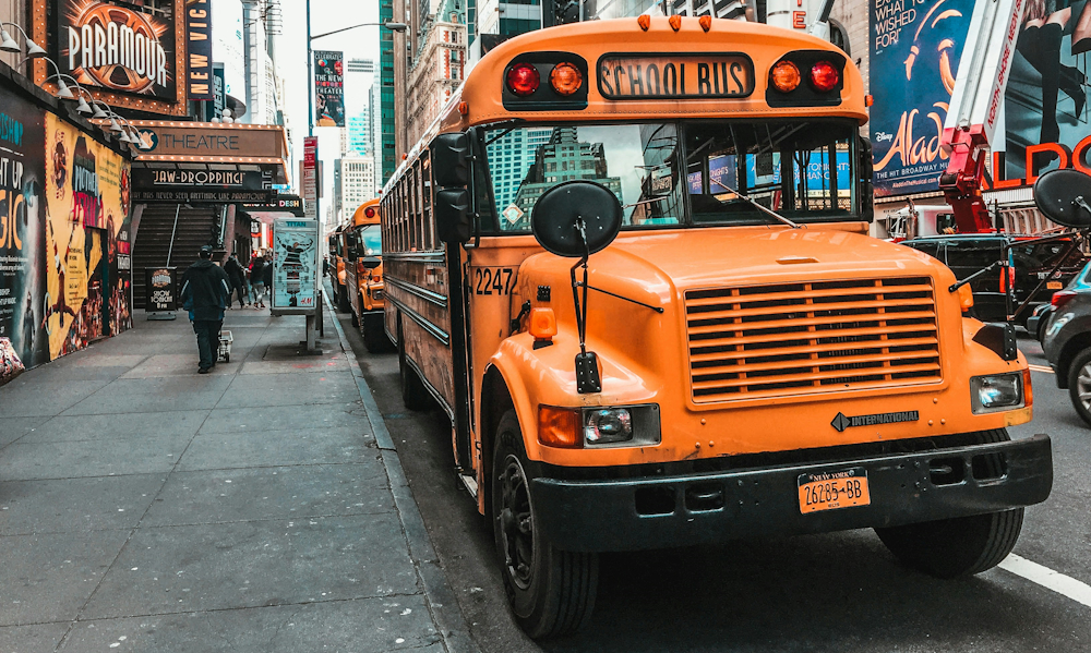 School Bus in Broadway in New York City by Jannis Lucas on Unsplash
