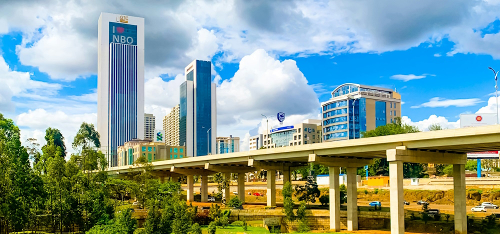 Expressway in Nairobi with skyscrapers in background by Sophie Maurine