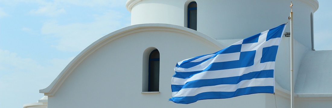 A Greek flag flying in front of a church by Oksana Avramenko