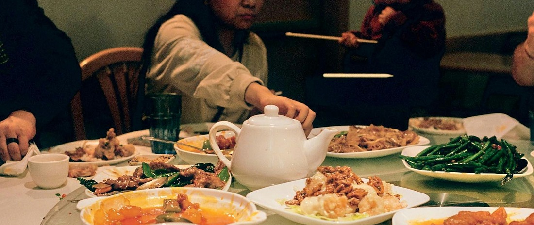 A group of people enjoying dinner together by Samuel Yongbo Kwon