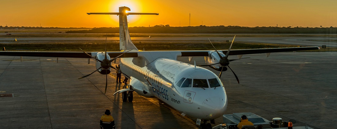 White passenger plane in Mérida, Mexico by Eddie Bugajewski