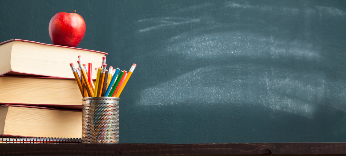 book pile, chalkboard, stationery