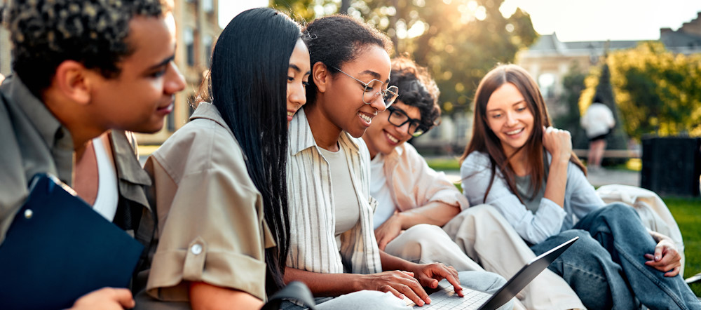 teens at school with laptop