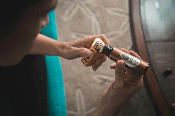 Person refilling a vape by VapeClubMy from Unsplash
